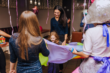 Little preschool girl, child and her mother, woman dancing, spinning indoors in a competition with...