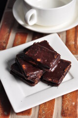 Chocolate covered biscuits on a white plate