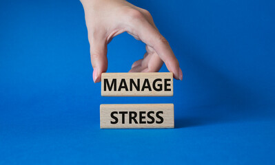 Manage stress symbol. Concept word Manage stress on wooden blocks. Beautiful blue background. Doctor hand. Business and Manage stress concept. Copy space