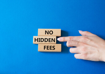 No hidden fees symbol. Concept word No hidden fees on wooden blocks. Businessman hand. Beautiful blue background. Business and No hidden fees concept. Copy space