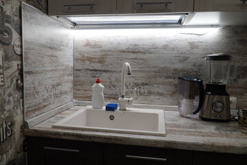 Electric food processor on kitchen countertop, kitchen sink on the background. kitchen applience concept