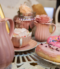 Assorted donuts with pink glazed and sprinkles donuts.
