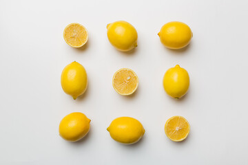 Many fresh ripe lemons as colored background, top view. Elegant background of lemon and lemon slices Top view flat lay