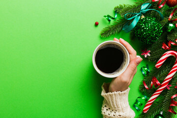 Woman holding cup of coffee. Woman hands holding a mug with hot coffee. Winter and Christmas time concept