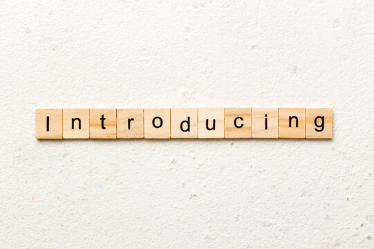 introducing word written on wood block. introducing text on table, concept