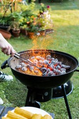 Vertical closeup of a barbecue grill with a burning charcoal