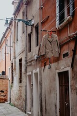 Fototapeta premium Vertical shot of a residential building with a hung suit in Venice, Italy