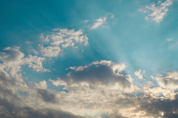 Fototapeta na wymiar sun rays with blue cloudy sky