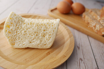 Close up of cheese, milk , brown bread and almond nut on table.