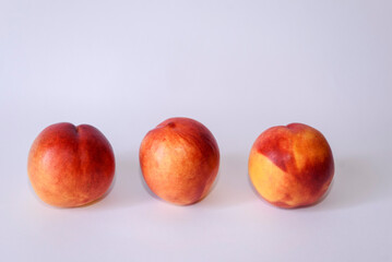 Large ripe peaches isolated on white background. Useful fruits close-up.