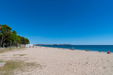Platja Esquirol sandy beach Cambrils Spain with view to Salou Catalonia and blue Mediterranean sea