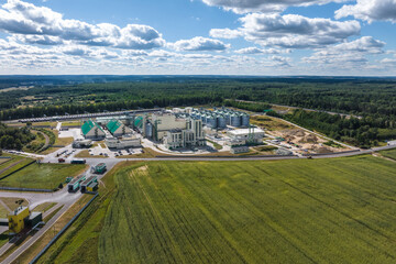 aerial view on rows of agro silos granary elevator with seeds cleaning line on agro-processing manufacturing plant for processing drying cleaning and storage of agricultural products