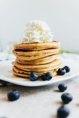 Vertical shot of Blueberry Pancakes with Whipped Cream