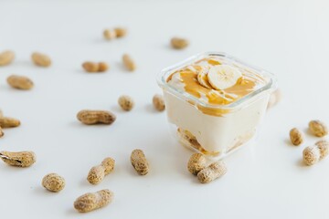 Closeup of a Peanut Butter Banana Mousse in a bowl surrounded by peanuts