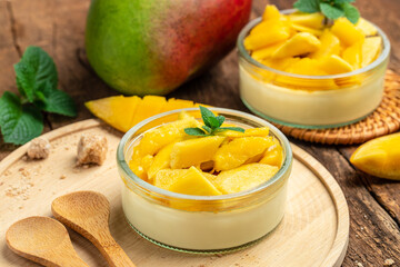 Mango desserts. panna cotta with pieces of fresh mango. Italian dessert. Food recipe background. Close up