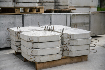 Reinforced concrete slabs for reinforcing road cuvettes, a stack of slabs in a warehouse of a...