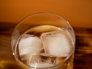 Iced tea in a glass with ice cubes. Cold tea with ice.