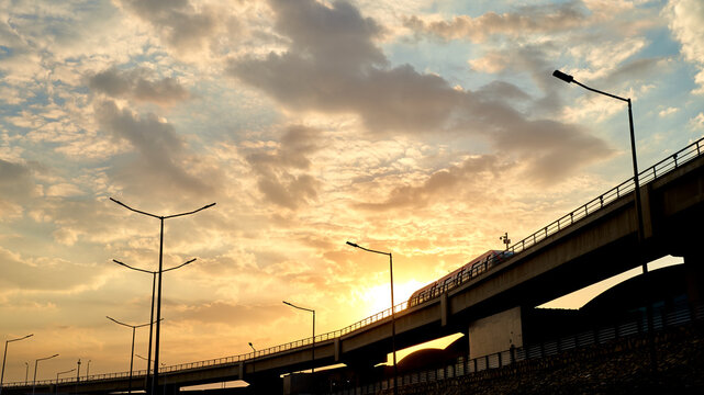 Metro train entering in to the station during sunset under the beautiful clouds at cairo international airport, CIA, Egypt