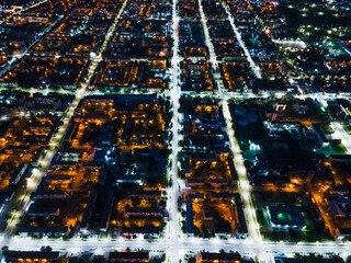 The nightlife of the city,the light of the night city from a height.Busy car traffic on city streets at night.Urban areas and the intersection of streets in the dark illuminated by lights and lanterns