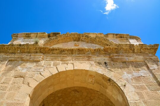 Low angle shot of the top of Hadrian's Arch, the arched gate of the ancient Romany city in Jerash