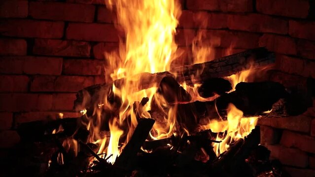 Firewood is burning in the fireplace