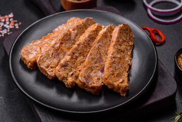 Tasty meat brawn or roll on a wooden cutting board with spices and herbs