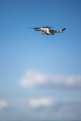 Vertical shot of a drone in the blue sky