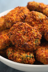Carrot and spinach vegan vegetarian bites in white bowl, party finger food.