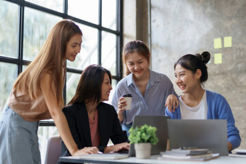 Group of young Asian business woman are meeting to present a new roadmap in product design with laptop computers in the office.