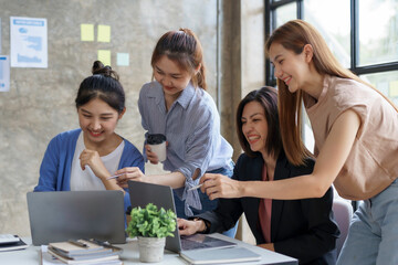 Group of young Asian business woman are meeting to present a new roadmap in product design with laptop computers in the office.