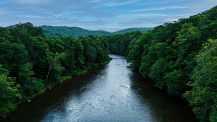 Aerial view of a river in greenery on a cloudy day in McHenry, Maryland