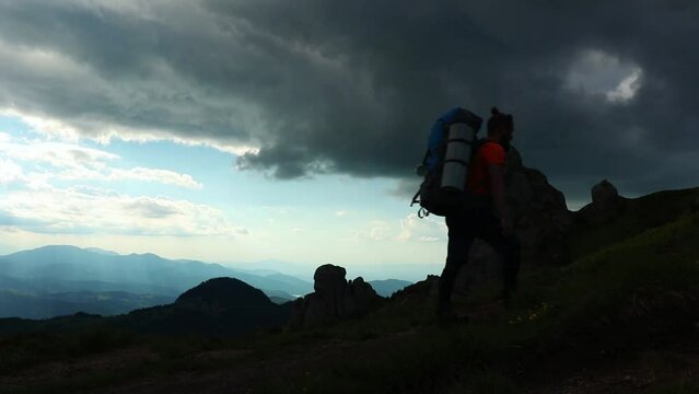 Hiker in the Ciucas mountain range under a cloudy sky