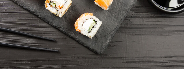 Obraz na płótnie Canvas Philadelphia roll sushi with salmon, prawn, avocado, cream cheese. Sushi menu. Japanese food.