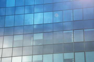 Fototapeta premium Reflection of clouds in mirrored windows of building