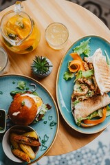 Vertical top view of a gourmet juicy burger and chicken tortillas on a restaurant table