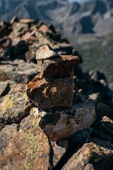 Vertical closeup of a stack of rocks on mountains