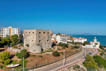 Fototapeta premium Coastal view of Oropesa del Mar, Spain, showing Torreon del Rey, guard tower, and lighthouse in the background,