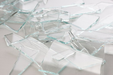 broken glass parts on white background closeup vertical photo