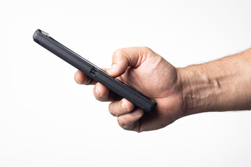 Hand and arm of a man holding a cell phone on a nuclear white background.