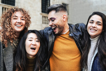 Happy young group of people having fun together outdoor in winter time - Focus on gay transgender...