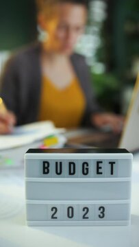 budget and tax time.accountant woman working in background.