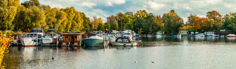 Fototapeta na wymiar POTSDAM, GERMANY - October 15 2022: Motor yacht club Tiefer See in the center of Potsdam. A cozy harbor restaurant with a view of the Havel and the castle park completes the offer.