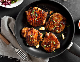 Roasted pork steaks in pan