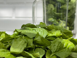 Fresh spinach leaves for making smoothies in a blender . The concept of detox and healthy eating.