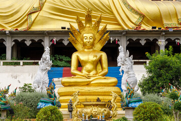 Golden Naga 7-headed Buddha image sitting in front of Wat Phra That Suthon Mongkhon Khiri, Den Chai District, Phrae Province, Thailand.