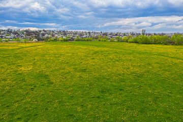 Blossom meadow and the village in springtime
