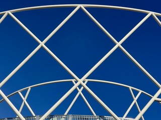 White metal pipes forming pattern structure against blue sky, modern architecture