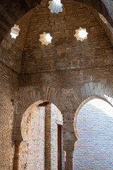 Techo abovedado con aperturas en forma de estrella para la entrada de luz en los antiguos baños árabes de la Alhambra de Granada, España - obrazy, fototapety, plakaty