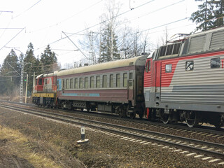 red technical train passes through the railway tracks in winter
