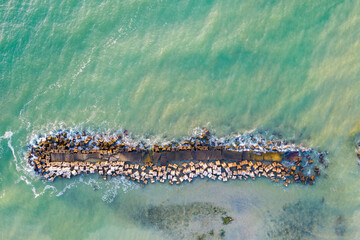 Wave breakers in a summer resort viewed from above - 545749027